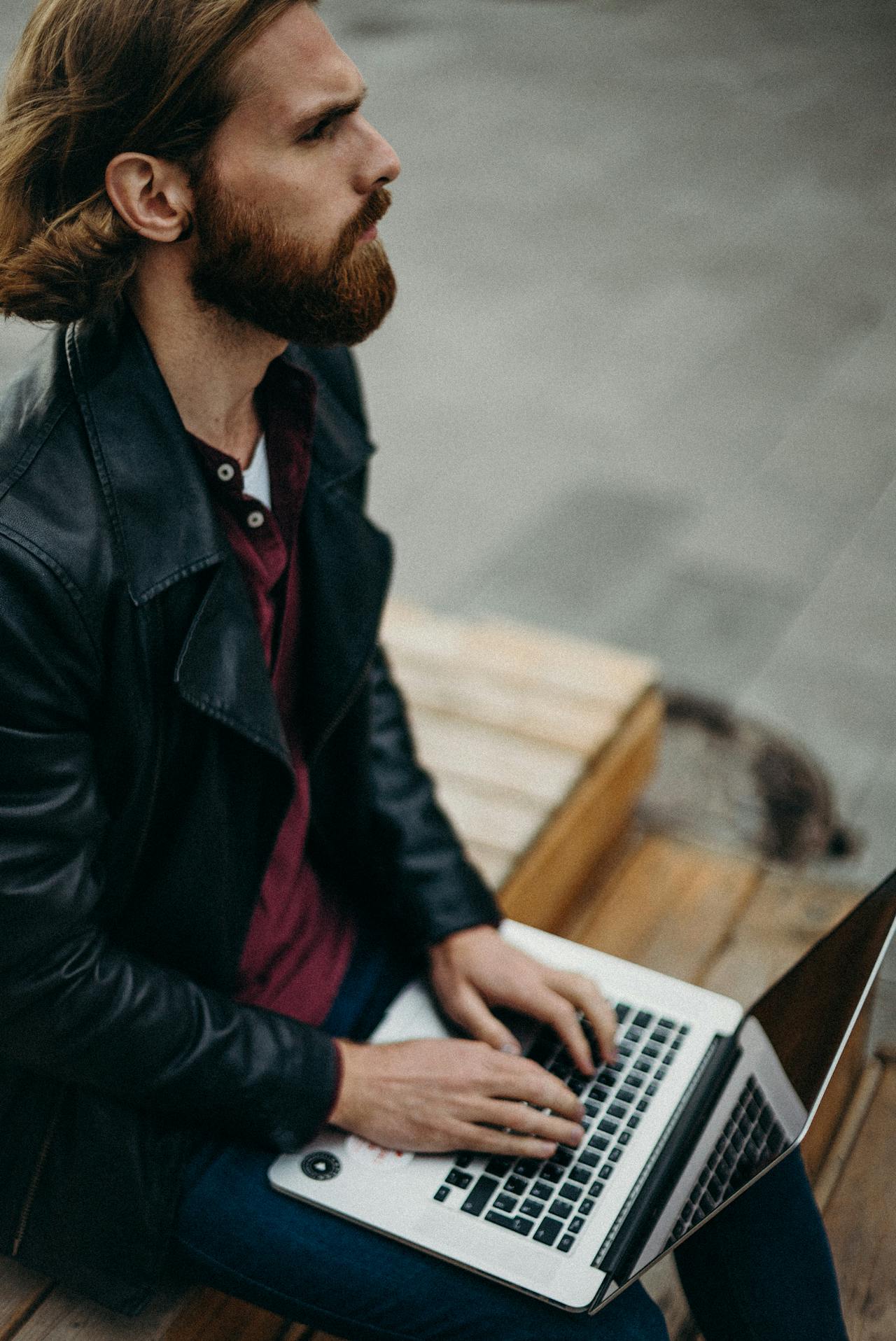 man working and thinking with laptop